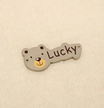 Нашивка "Lucky" 40*18мм бежевого цвета