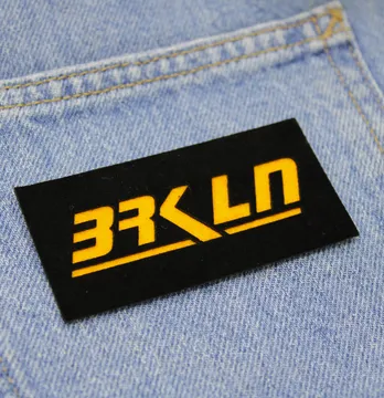 Нашивка "BRKLN" 80*40 мм чорного кольору з помаранчевим написом