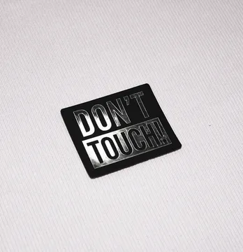Нашивка "Don't touch" 60*50 мм чорного кольору за срібним лого