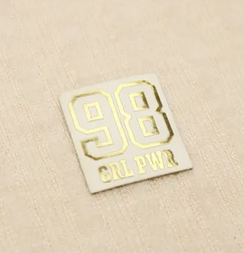 Нашивка "98 Girl Power" 30*27мм белого цвета с золотой надписью.
