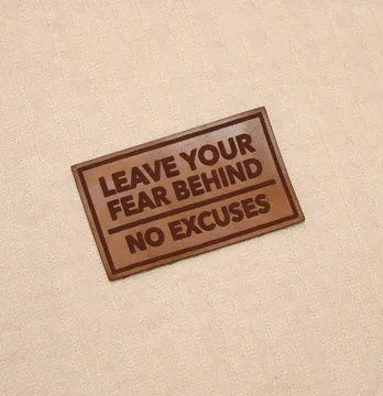 Нашивка "Leave your fear behind / no excuses" 65*40 мм коричневого кольору