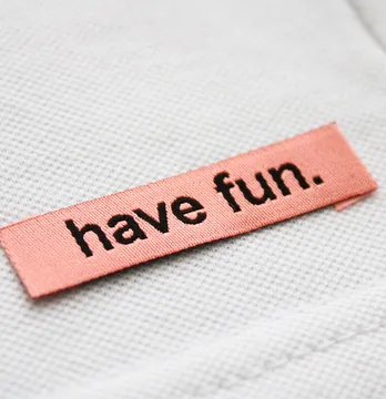 Бирка жаккардовая "Have fun" 50*12 мм персикового цвета с черным лого.